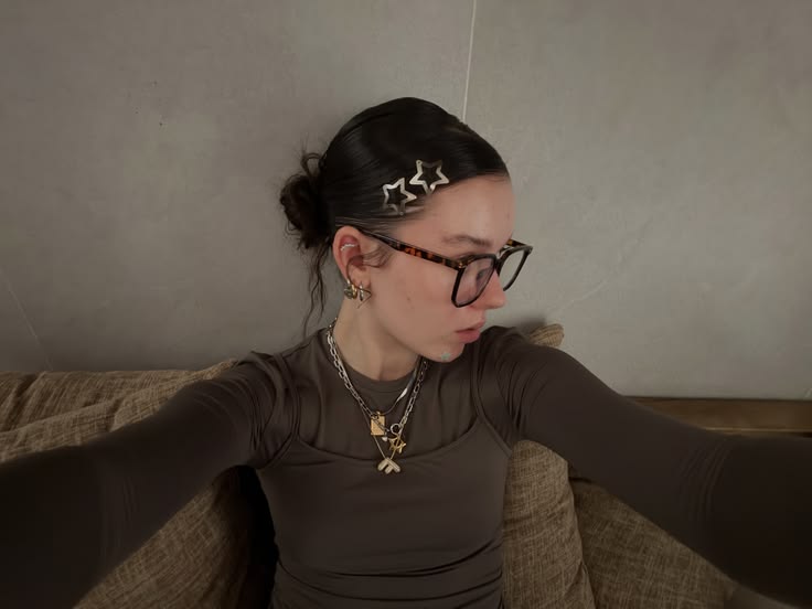 A sleek, slick-back bun with gel and hairclips as decoration.