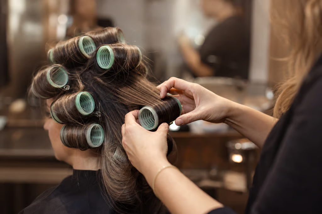 Bigger rods and rollers create the soft, loose bends of a modern perm, a world away from the tight uniform curl of the eighties.