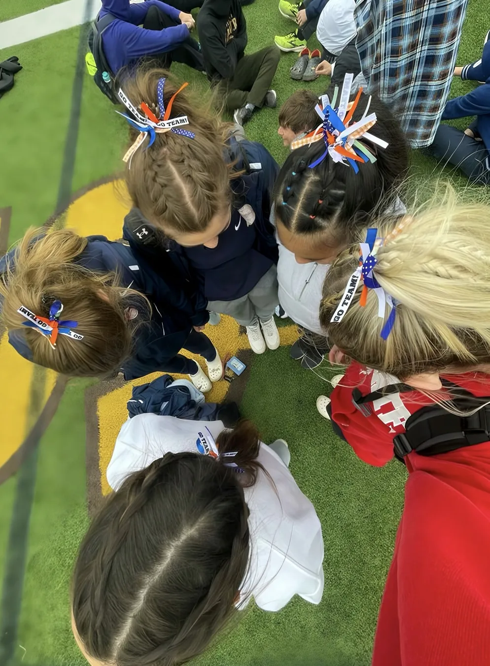 Bright cobalt ribbon on a braided ponytail for U.S. Open energy