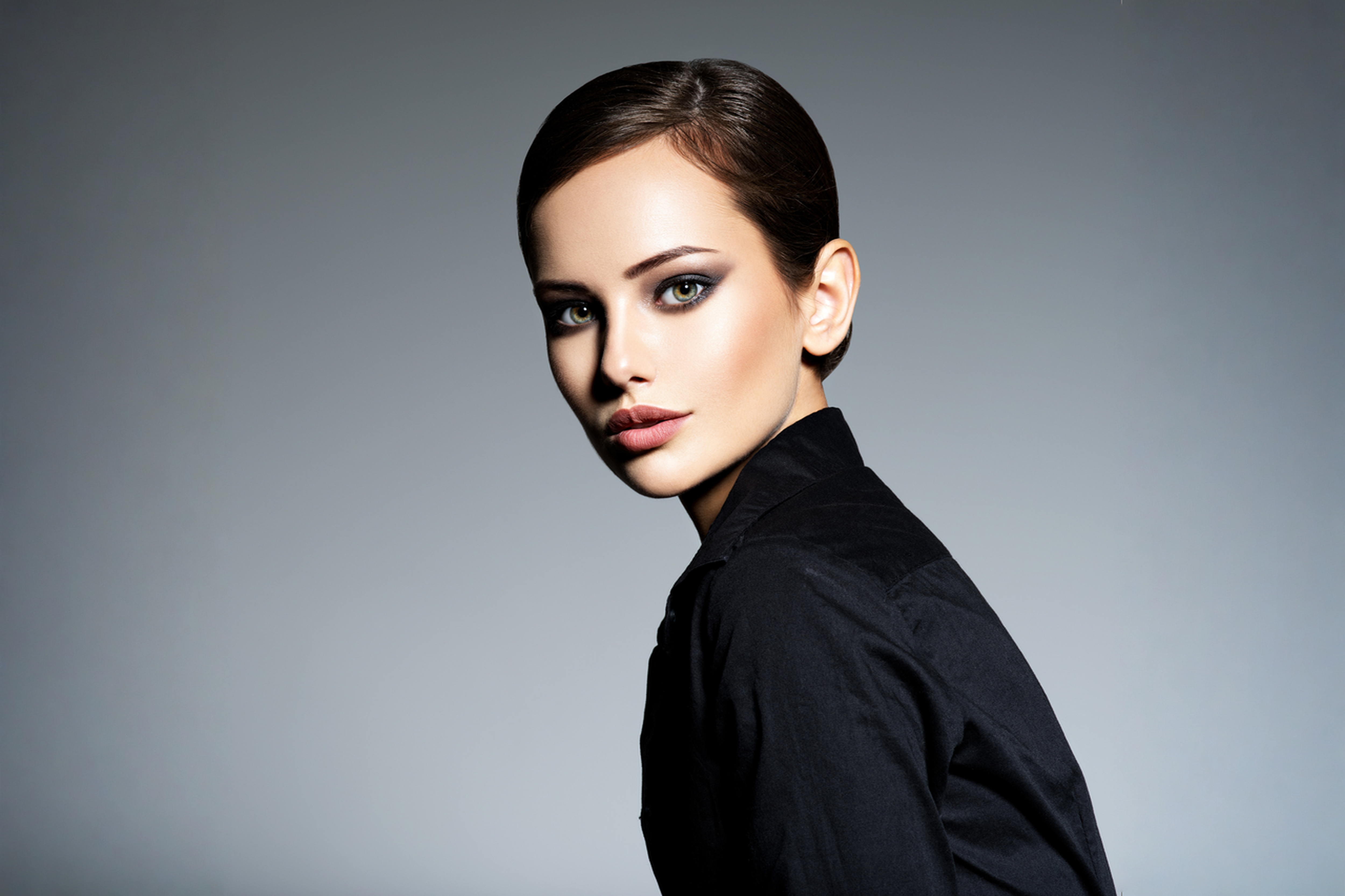 A polished slick-back on a model, the kind of finish that reads editorial, not rushed